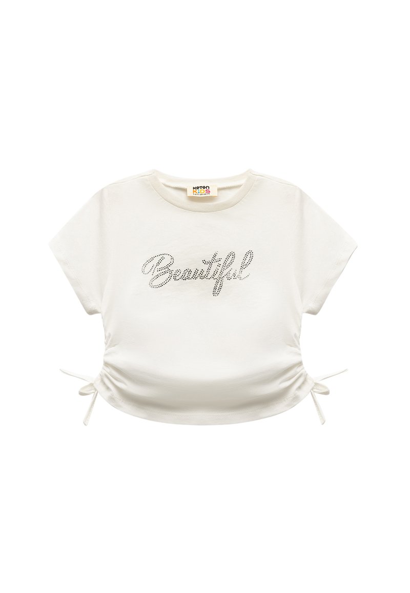 Weißes T-Shirt mit kurzen Ärmeln, auf dem "Beautiful" in Strass gedruckt ist. Verfügt über verstellbare Seitenschlaufen und einen runden Halsausschnitt. Aus softem Baumwollmaterial.