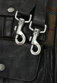 Zwarte leren tas met zilveren metalen hardware, inclusief twee clipsluitingen en een textuur exterior. Accenten van kleurrijke geweven stof.