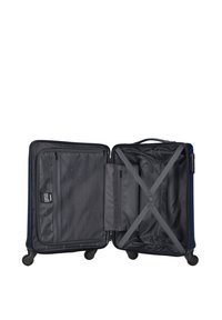 Navy hard-shell suitcase open to reveal a grey interior, featuring a cross strap, mesh pocket, and zip closure. Four wheels for mobility.