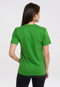Green cotton t-shirt with short sleeves and a round neckline, featuring a smooth texture and a fitted cut. No visible logos or patterns.