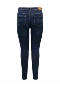 Slim jeans i mörkblå denim med en slät yta, med två bakfickor och en brun läderetikett vid midjan.