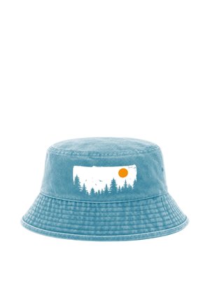 Blue bucket hat with a white rectangular graphic showing pine trees, birds, and an orange sun on the front.
