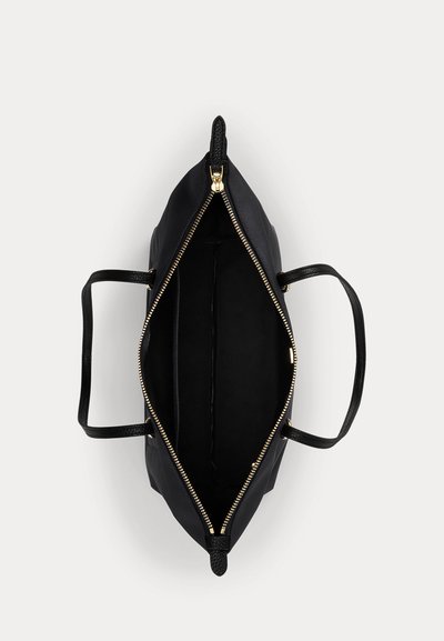 Sac cabas noir avec fermeture éclair dorée ouverte, montrant l'intérieur vide et des doubles poignées plates sur fond blanc.