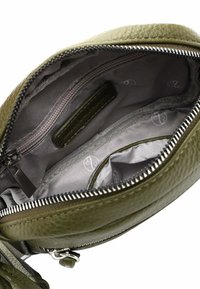 Green leather bag interior, featuring a zippered pocket, gray lining with patterned logo, and multiple compartments for organization.