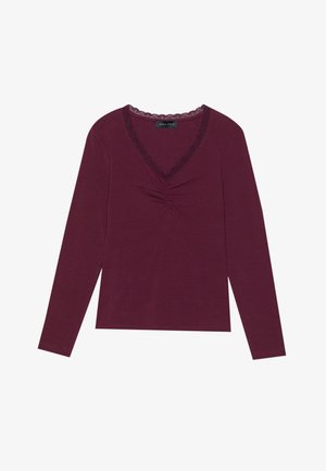 Long-sleeve, deep burgundy top featuring a V-neckline with black lace trim and gathered detailing at the center front. Soft texture, casual fit.