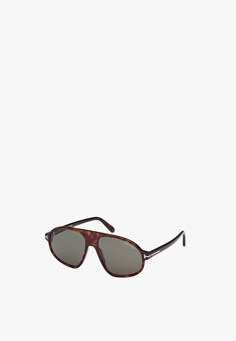 Majolikové slnečné okuliare s tmavými sklami, tvarom inšpirovaným pilotnými okuliarmi, štíhlymi kovovými akcentmi na ramenách a lesklým povrchom.