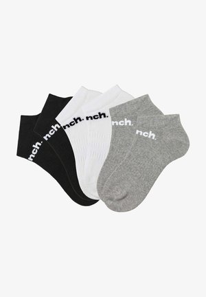Ein Sortiment an Knöchelsocken in Schwarz, Weiß und Grau, mit einem gerippten Design und einem Logo, das sich oben erstreckt.