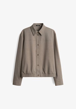 Gray collared jacket with a button-down front, elasticized hem, and textured fabric. Includes two pockets on the chest and long sleeves.