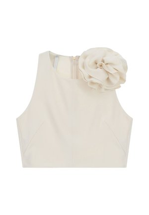 Top corto beige senza maniche con un grande fiore di stoffa sulla spalla sinistra e chiusura con cerniera sul retro.