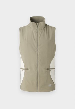 Lightweight, sleeveless vest in khaki with a high collar, front zipper, and white side panels. Includes two zippered pockets.