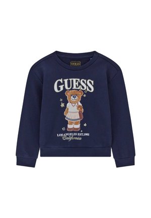 Marineblauwe sweatshirt met een beer in een rok die een tas vasthoudt, met de tekst "GUESS" en "Los Angeles Est. 1981 California" eronder.