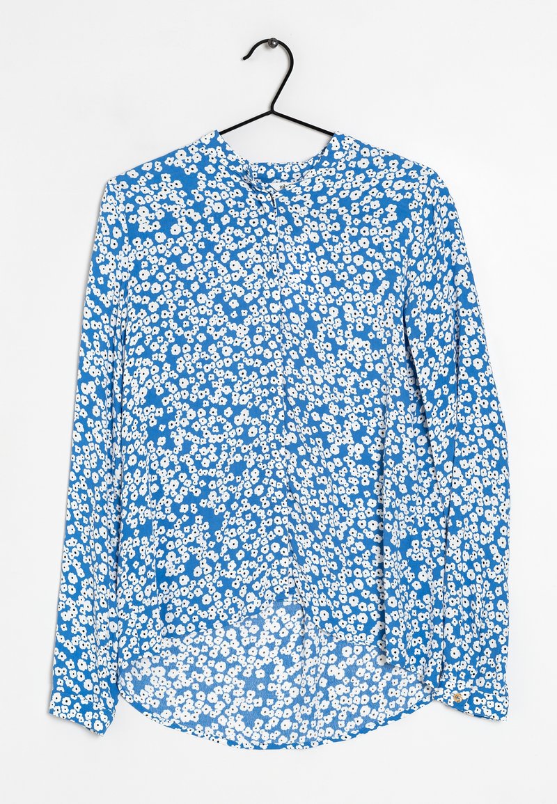 Blå långärmad blus med ett blommönster som har vita blommor, rundad nederkant och knäppning vid halsen. Lättviktig tyg.