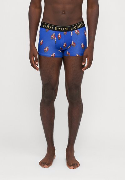 Plave bokserice s ponavljajućim uzorkom papige, s crnim pojasom na kojem je zlatnim slovima ispisan logo "POLO RALPH LAUREN".