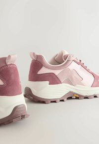 Rosa Wildleder- und Mesh-Sneaker mit einer klobigen weißen Sohle. Strukturierte Akzente und ein Vibram-Logo auf der Laufsohle. Zwei Zuglaschen an der Ferse.
