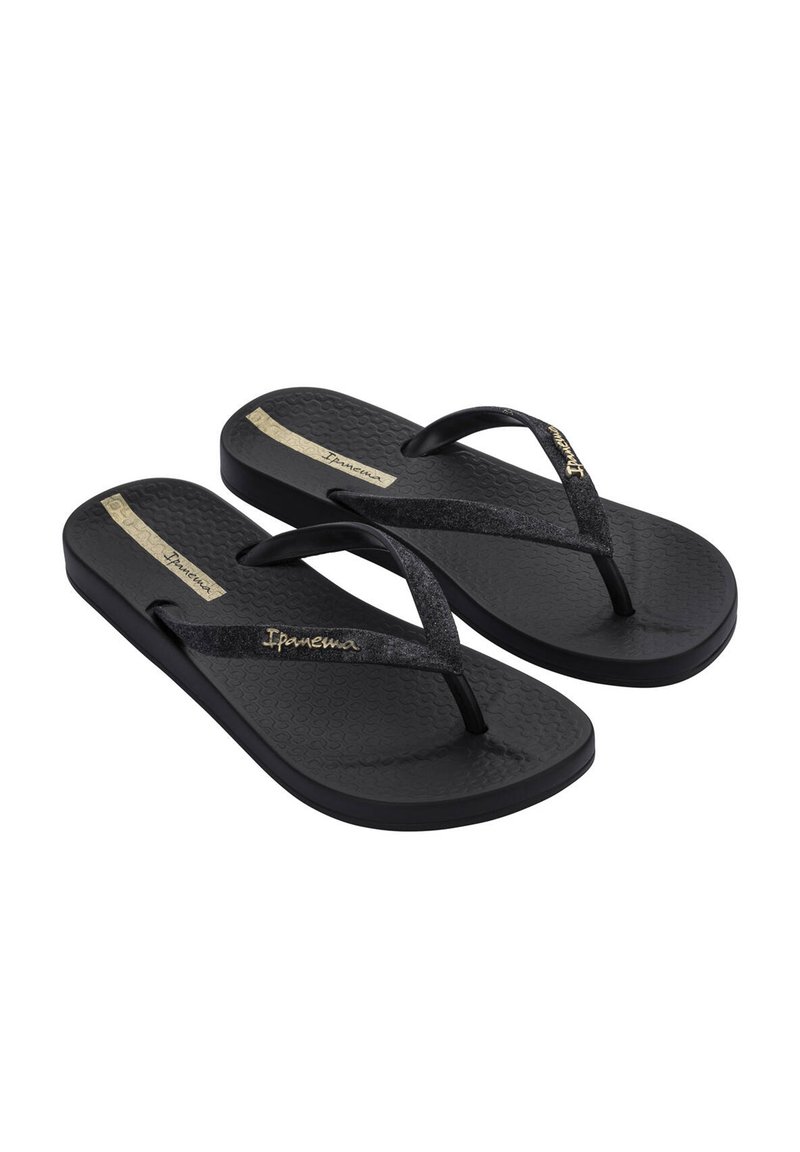 Black flip-flops with textured soles, featuring shiny black straps and a metallic gold logo accent. Durable design suitable for casual wear.