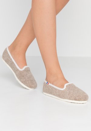 Brown felt slippers with white edging, slip-on design, and textured fabric. Features a small red, white, and blue accent on the side.