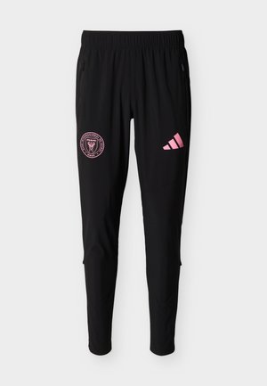 Pantalones deportivos negros con cintura elástica, logo rosa del club de fútbol Miami en el muslo izquierdo y logo rosa de Adidas en el muslo derecho.