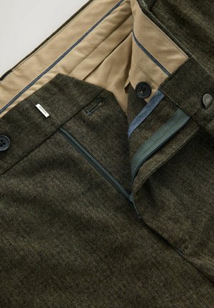 Houndstooth-patterned trousers in dark green, featuring a beige lining, blue accents, button closures, and zippered pockets.