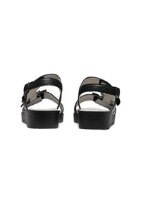 Schwarze Ledersandalen mit verstellbaren Riemen, strukturiertem Finish und einer dicken, robusten schwarzen Sohle. Merkmale sind ein minimalistisches Design und ein glattes Innenfutter.