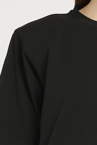 T-shirt nera con vestibilità rilassata, maniche corte e scollatura rotonda, realizzata in tessuto morbido e texturizzato. Design minimalista senza motivi.