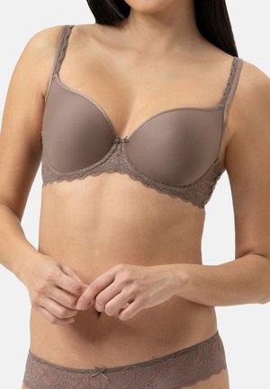 Brown padded bra with lace trim along the top, adjustable straps, and a small bow detail at the center. Smooth texture and structured design.