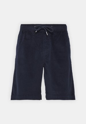 Pantaloni corti in velluto a coste blu navy con vita elasticizzata, chiusura con coulisse e tasche laterali. Tessuto testurizzato con un sottile motivo a righe.