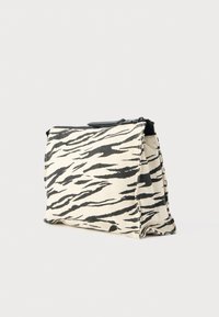 Τσαντάκι με σχέδιο ζέβρας από καμβά με κλείσιμο με φερμουάρ. Διαθέτει κρεμ βάση με μαύρες ρίγες και συμπαγή, ορθογώνιο σχήμα.