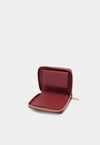 Portefeuille zippé en cuir bourgogne avec quincaillerie dorée. À l'intérieur, il y a des fentes pour cartes et une poche transparente pour carte d'identité. Texture lisse. Design compact.