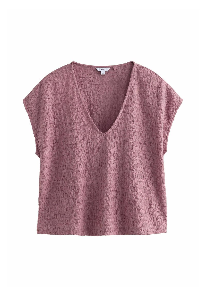 Top corto a maniche corte rosa, testurizzato, con scollatura a V profonda e vestibilità ampia. Il tessuto presenta un motivo sottile, creando un design leggero e traspirante.