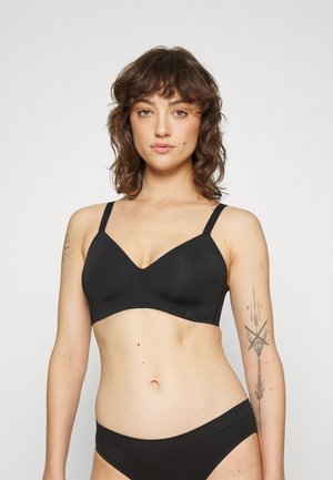 Black wireless bra with a v-neck design, made of smooth material, featuring adjustable straps and a seamless finish.