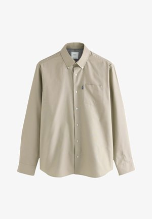 Camicia beige a maniche lunghe con colletto, taschino sul petto singolo e texture del tessuto liscia. Presenta bottoni bianchi e orlo dritto.