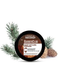 L'Oréal BarberClub Skäggstylingpomad i en rund svart behållare med en brun etikett som har ett träfibrigt mönster och har inslag av tall.