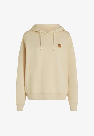 Jasno beżowy hoodie wykonany z miękkiego materiału, z przednią kieszenią i okrągłym logo na lewej piersi. Rękawy zakończone ściągaczem.