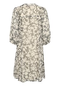 Blumenmuster-Kleid mit cremefarbener Basis und schwarzen Blattmustern, mit lockeren Ärmeln und einem knielangen Saum. Leichtes, durchscheinendes Material.