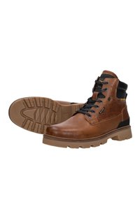 Brown leather ankle boots with black laces, padded black collar, and rugged tan rubber soles, styled for outdoor or casual wear.