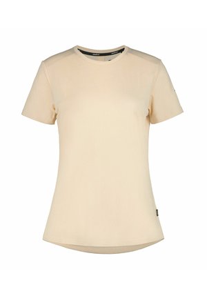Beżowy t-shirt z krótkim rękawem i okrągłym dekoltem, z lekko zakrzywionym dołem i małą metką na bocznym szwie.