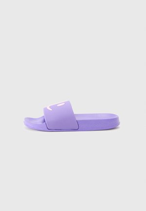 Purple slide sandal made of smooth rubber with a wide strap featuring a light pink smiley face design on the top. Flat sole.