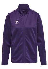 Lila zip-up jacka i mjuk textil med hög krage, två sidfickor och kontrasterande vit chevron-design på axlarna.