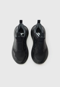 Zapatillas deportivas negras con parte superior de malla texturizada, diseño elástico sin cordones y cuello acolchado. Presentan detalles grises y suela de goma.