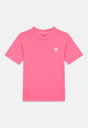 Rózsaszín pamut póló rövid ujjakkal, kerek nyakkivágással és egy kis fehér Adidas logóval a bal mellkason. Puha, sima tapintású.