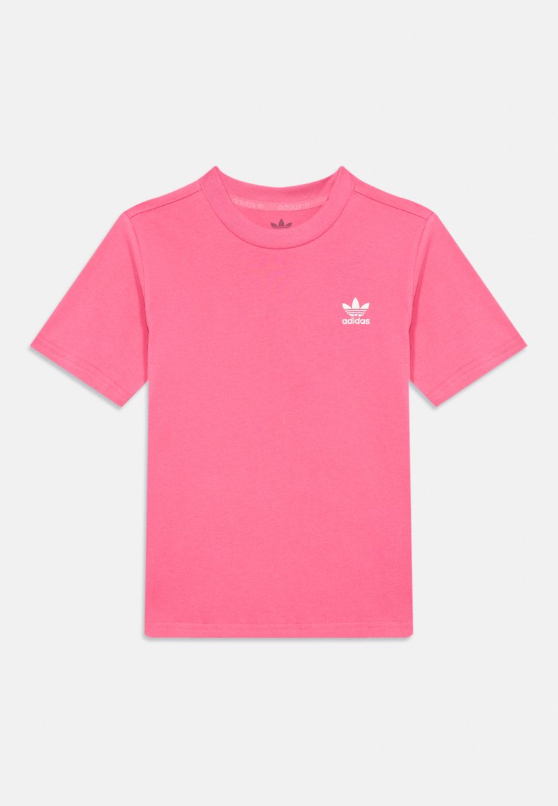 Roza bombažna majica s kratkimi rokavi, okroglo izrezana in z majhnim belim logotipom Adidas na levi prsni strani. Mehka, gladka tekstura.