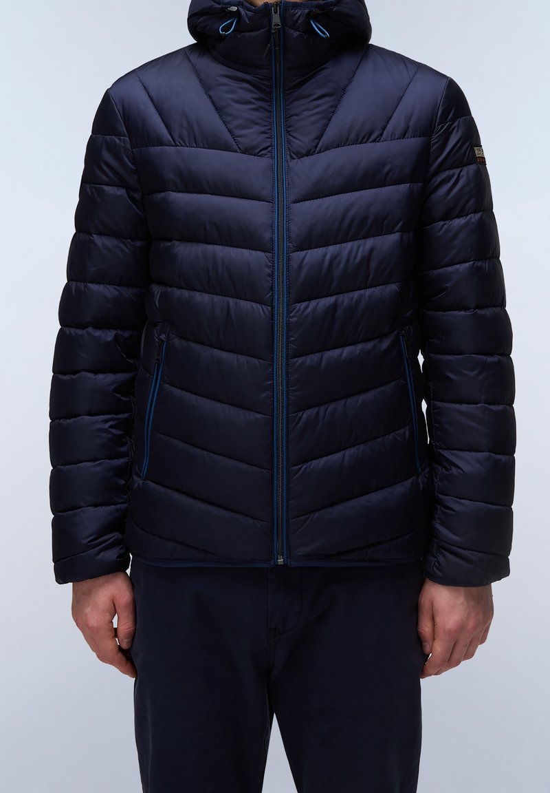 Granatowa kurtka puchowa z zamkiem z przodu, wysokim kołnierzem i kapturem. Wzór chevron oraz niebieskie akcenty podkreślają design. Gładka faktura.