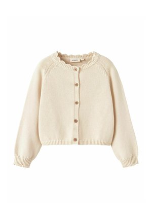 Gilet tricoté couleur crème avec un col volanté, des manches longues et cinq boutons en bois sur le devant. Longueur raccourcie.