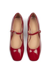 Red patent leather Mary Jane shoes with a rounded toe, adjustable buckle strap, and smooth interior lining.