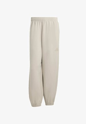 Lichtbeige sweatpants met een elastische tailleband, taps toelopende manchetten en een subtiele reliëflogo op de linker bovenbeen. Glad stoftextuur.