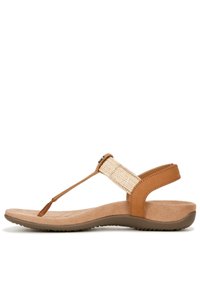 Sandale marron avec une sangle en tissu tissé, semelle en daim lisse et un lit de pied rembourré. Dispose d'un design en T et d'une sangle de cheville réglable.