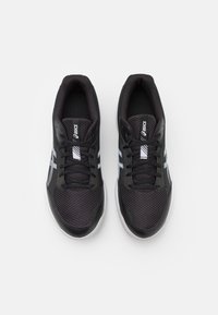 Black athletic shoes featuring a mesh upper, flat laces, and a white logo with grey accents. Cushioned sole for enhanced comfort.