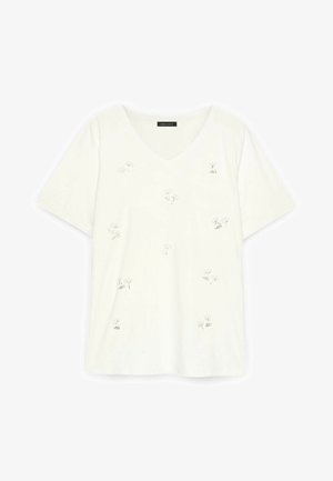 T-shirt bianca a maniche corte con scollo a V e piccolo, delicato ricamo floreale sparso sul davanti.