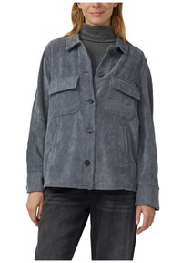 Gray corduroy jacket with a button front, two chest pockets, and long sleeves. Features vertical ribbed texture and a relaxed fit.