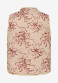 Quilted vest in light pink fabric with a floral pattern featuring orange, pink, and cream flowers. Edged with a cream trim.